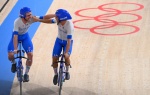 Italy's Simone Consonni (L) and Italy's Francesco Lamon celebrate after winning gold and setting a new World Record in the men's track cycling team pursuit finals during the Tokyo 2020 Olympic Games at Izu Velodrome in Izu, Japan, on August 4, 2021. (Phot