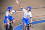 Italy's Simone Consonni (L) and Italy's Filippo Ganna celebrate after winning gold and setting a new World Record in the men's track cycling team pursuit finals during the Tokyo 2020 Olympic Games at Izu Velodrome in Izu, Japan, on August 4, 2021. (Photo 