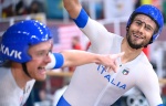 Italy's Simone Consonni (L) and Italy's Filippo Ganna celebrate after winning gold and setting a new World Record in the men's track cycling team pursuit finals during the Tokyo 2020 Olympic Games at Izu Velodrome in Izu, Japan, on August 4, 2021. (Photo 