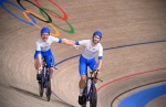 Italy's Simone Consonni (L) and Italy's Filippo Ganna celebrate after winning gold and setting a new World Record in the men's track cycling team pursuit finals during the Tokyo 2020 Olympic Games at Izu Velodrome in Izu, Japan, on August 4, 2021. (Photo 