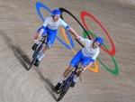Italy's Simone Consonni (L) and Italy's Filippo Ganna celebrate after winning gold and setting a new World Record in the men's track cycling team pursuit finals during the Tokyo 2020 Olympic Games at Izu Velodrome in Izu, Japan, on August 4, 2021. (Photo 