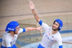 Italy's Simone Consonni (L) and Italy's Filippo Ganna celebrate after winning gold and setting a new World Record in the men's track cycling team pursuit finals during the Tokyo 2020 Olympic Games at Izu Velodrome in Izu, Japan, on August 4, 2021. (Photo 