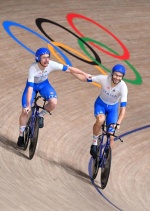 Italy's Simone Consonni (L) and Italy's Filippo Ganna celebrate after winning gold and setting a new World Record in the men's track cycling team pursuit finals during the Tokyo 2020 Olympic Games at Izu Velodrome in Izu, Japan, on August 4, 2021. (Photo 