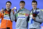Bronze medallist USA's Nic Fink (R), Silver medallist Netherlands' Arno Kamminga (L) and Gold medallist Italy's Nicolo Martinenghi pose with their medals following the men's 100m breaststroke finals the Budapest 2022 World Aquatics Championships at Duna A