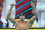 Italy's Nicolo Martinenghi celebrates taking gold in the men's 100m breaststroke finals the Budapest 2022 World Aquatics Championships at Duna Arena in Budapest on June 19, 2022. (Photo by Ferenc ISZA / AFP)