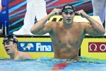 Italy's Nicolo Martinenghi celebrates taking gold in the men's 100m breaststroke finals the Budapest 2022 World Aquatics Championships at Duna Arena in Budapest on June 19, 2022. (Photo by Ferenc ISZA / AFP)