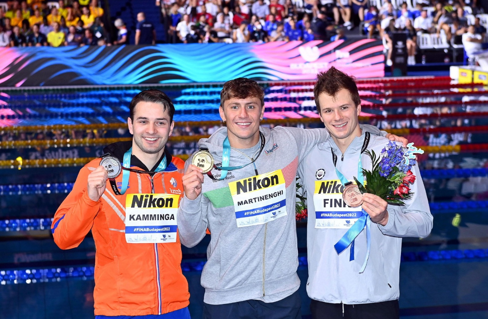 epa10022507 Nicolo Martinenghi (C) of Italy poses with his gold medal after winning the men's 100m Breaststroke final of the Swimming events at the 19th FINA World Aquatics Championships in Budapest, Hungary, 19 June 2022. Martinenghi won ahead of second 