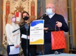 VARESE CONSIGLIO COMUNALE STRAORDINARIO 5 APRILE 2022 CON TESTIMONIANZA DI UNA DONNA UCRAINA FUGGITA DALLA GUERRA CON LA FAMIGLIA NELLA FOTO MONS PANIGHETTI DONA UN LIBRO A TATIANA ZALIZNA