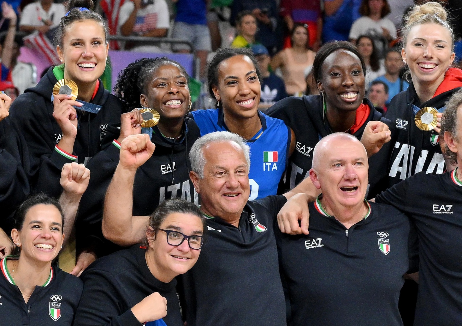 Italy's players with their coach Julio Velasco celebrate on the podium after winning the Women's gold medal match between USA and Italy of the Volleyball competitions in the Paris 2024 Olympic Games, at the South Paris Arena in Paris, France, 11 August 20
