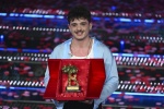 Italian singer Olly poses with the trophy the Sanremo Italian Song Festival on stage at the Ariston theatre during the 75th edition of the Sanremo Italian Song Festival, in Sanremo, Italy, 15 February 2025. The music festival will run from 11 to 15 Februa