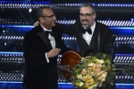 Italian singer Brunori Sas (R) and R) and Sanremo Festival host and artistic director Carlo Conti on stage at the Ariston theatre during the 75th edition of the Sanremo Italian Song Festival, in Sanremo, Italy, 15 February 2025. The music festival will ru