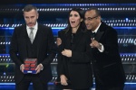 (L-R) CEO of TIM, Pietro Labriola, Italian singer Giorgia and Sanremo Festival host and artistic director Carlo Conti on stage at the Ariston theatre during the 75th edition of the Sanremo Italian Song Festival, in Sanremo, Italy, 15 February 2025. The mu