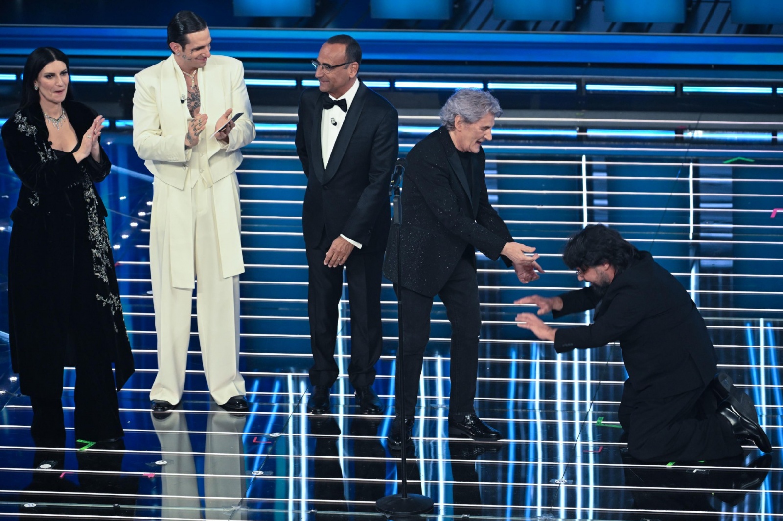 (L-R) Italian singers Laura Pausini, Achille Lauro, Sanremo Festival host and artistic director Carlo Conti, Italian singer Fausto Leali and Italian actor Lillo Petrolo on stage at the Ariston theatre during the 76th edition of the Sanremo Italian Song Fe