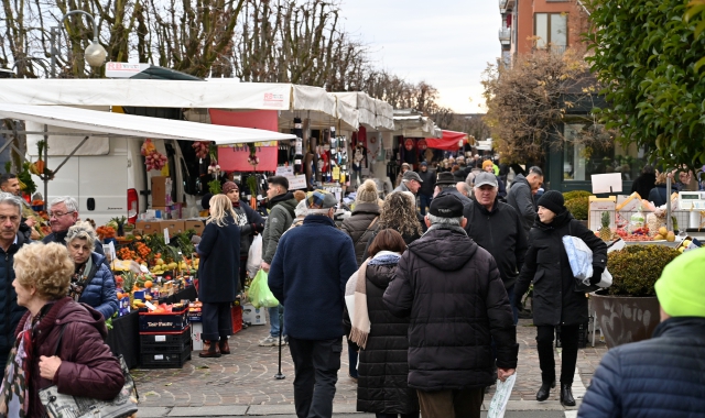 Un cartello di saluto agli ambulanti e ai clienti del mercato esposto da un locale pubblico