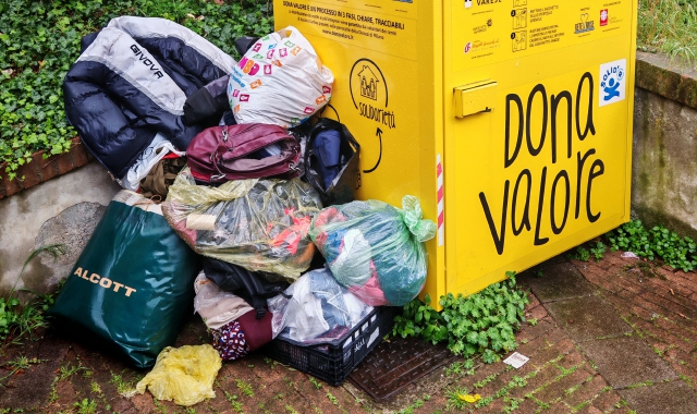 I sacchi con gli indumenti usati lasciati fuori dal contenitore